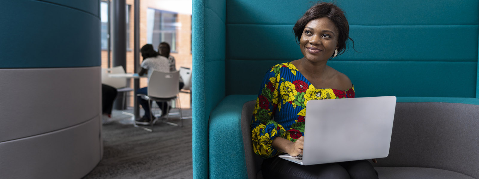 A student working on a laptop in a study space