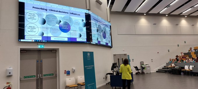 Conference speaker in lecture theatre