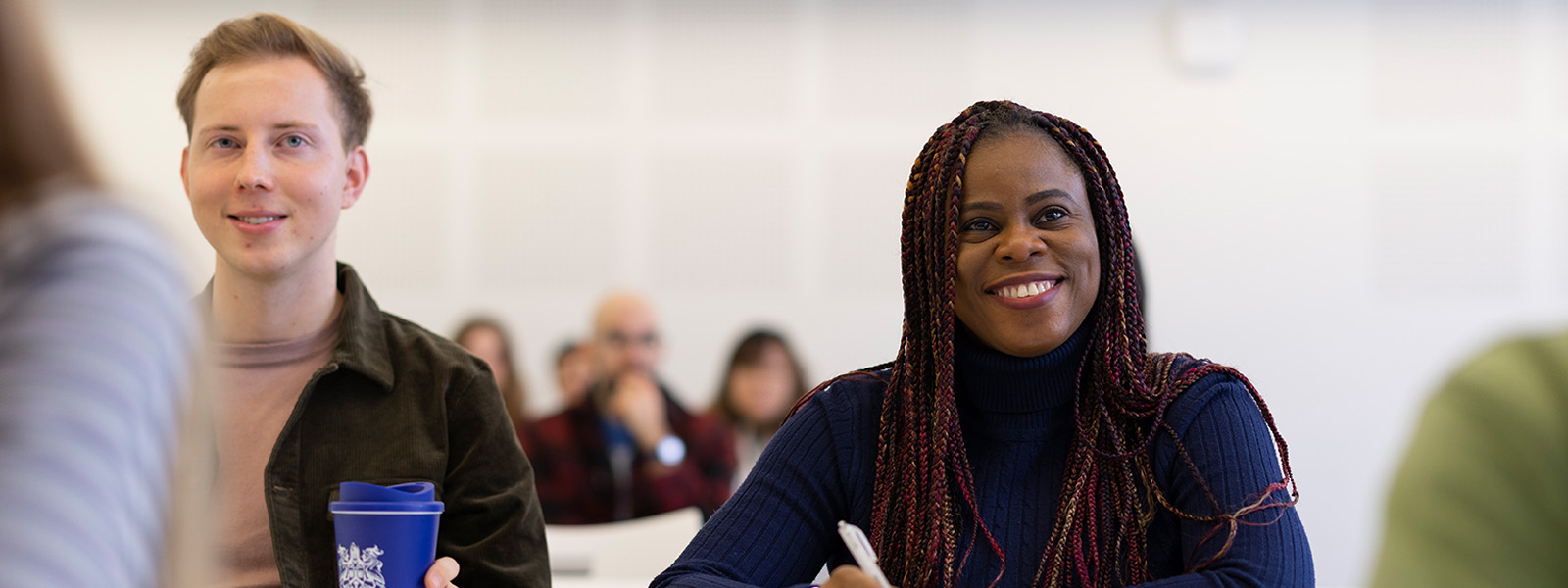 A male and female student sat at a table smiling