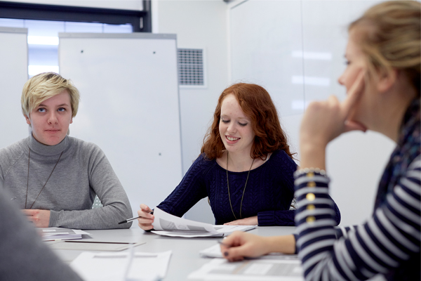 Students sat at a table smiling