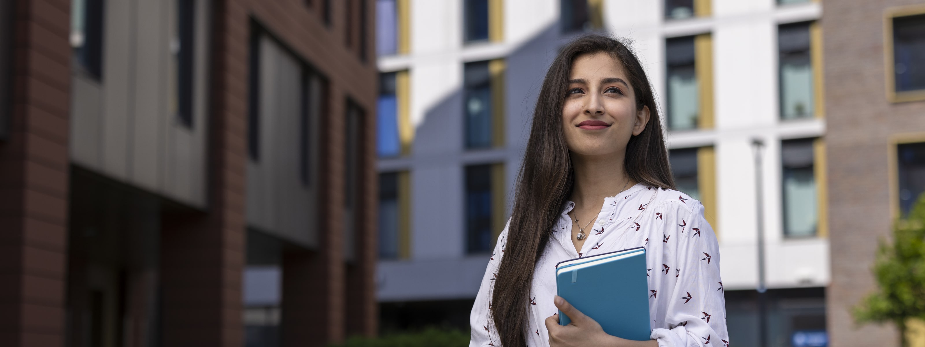 A student holding a book