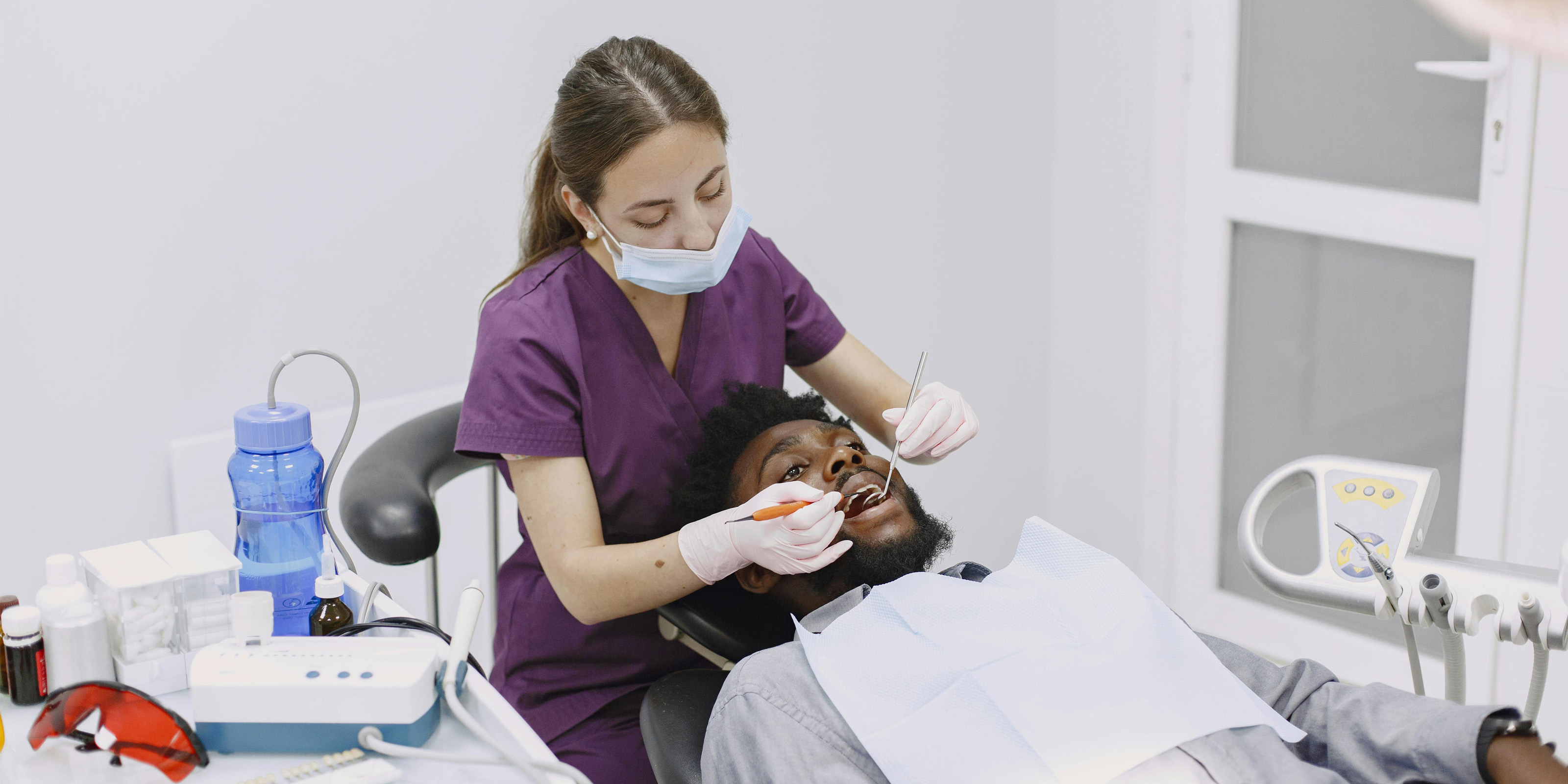A dental hygienist working with a patient