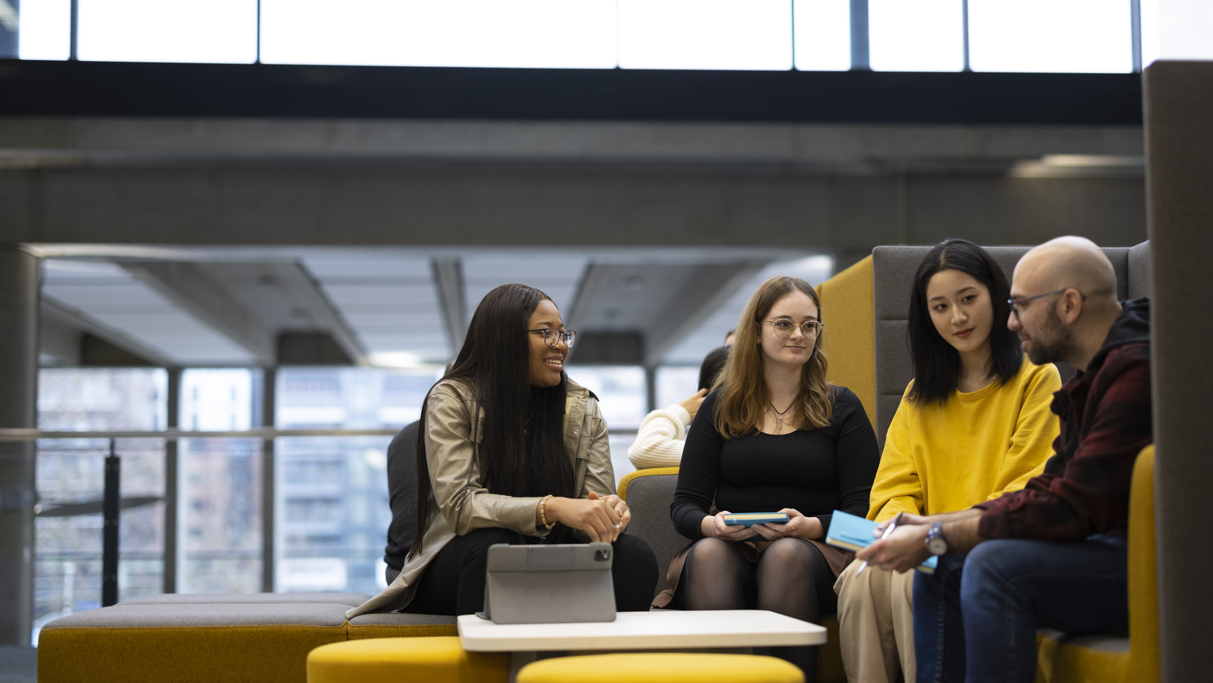 Students sit discussing in a study area