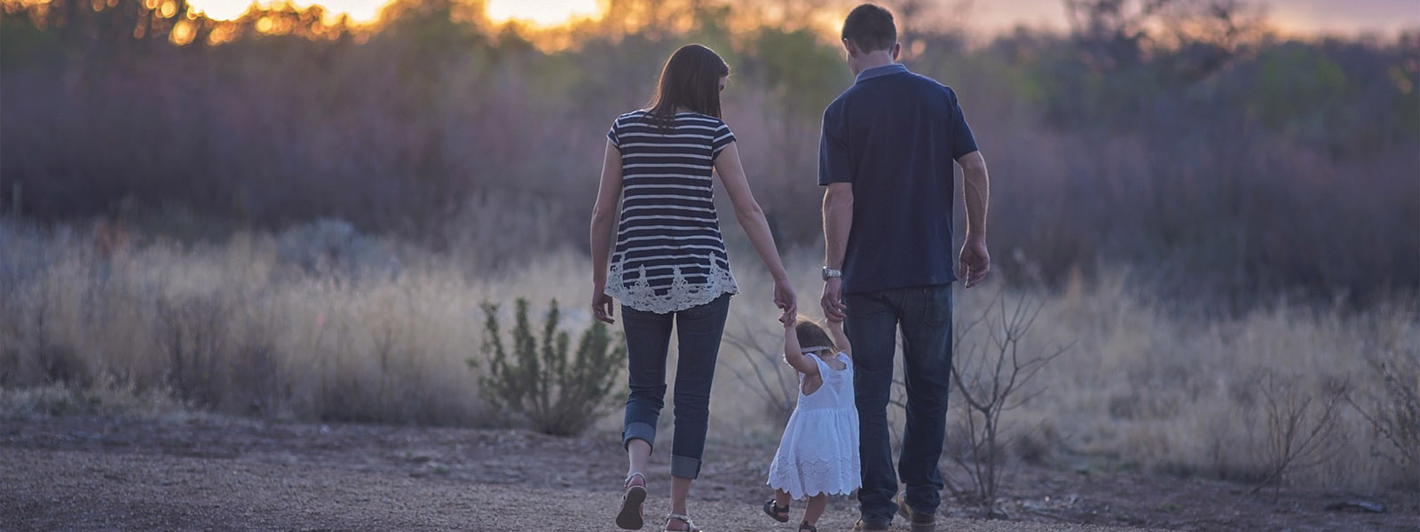 A mum and dad walking with their child
